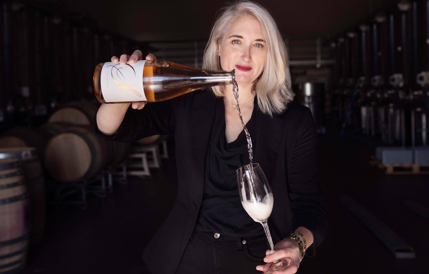 Winemaker Kate Payne Brown pours a glass of sparkling wine.